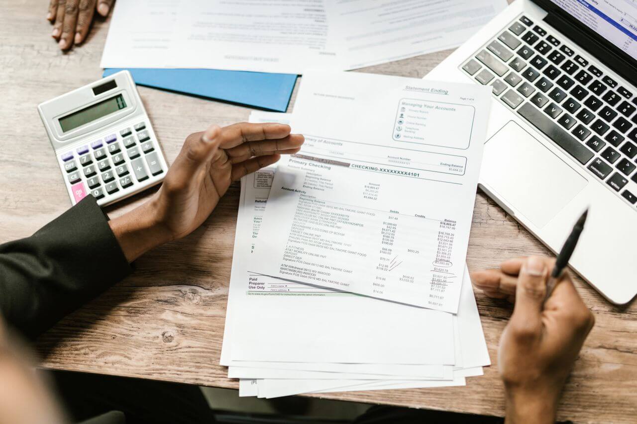 Person calculating money market account interest on a laptop